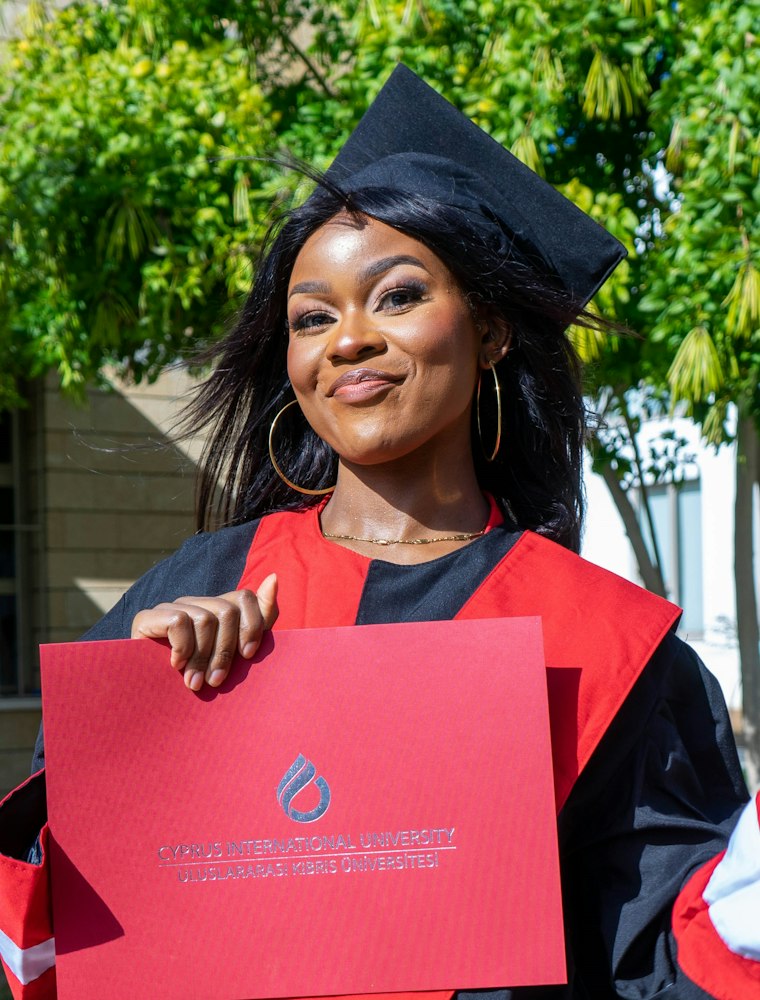 Graduate holding her certificate