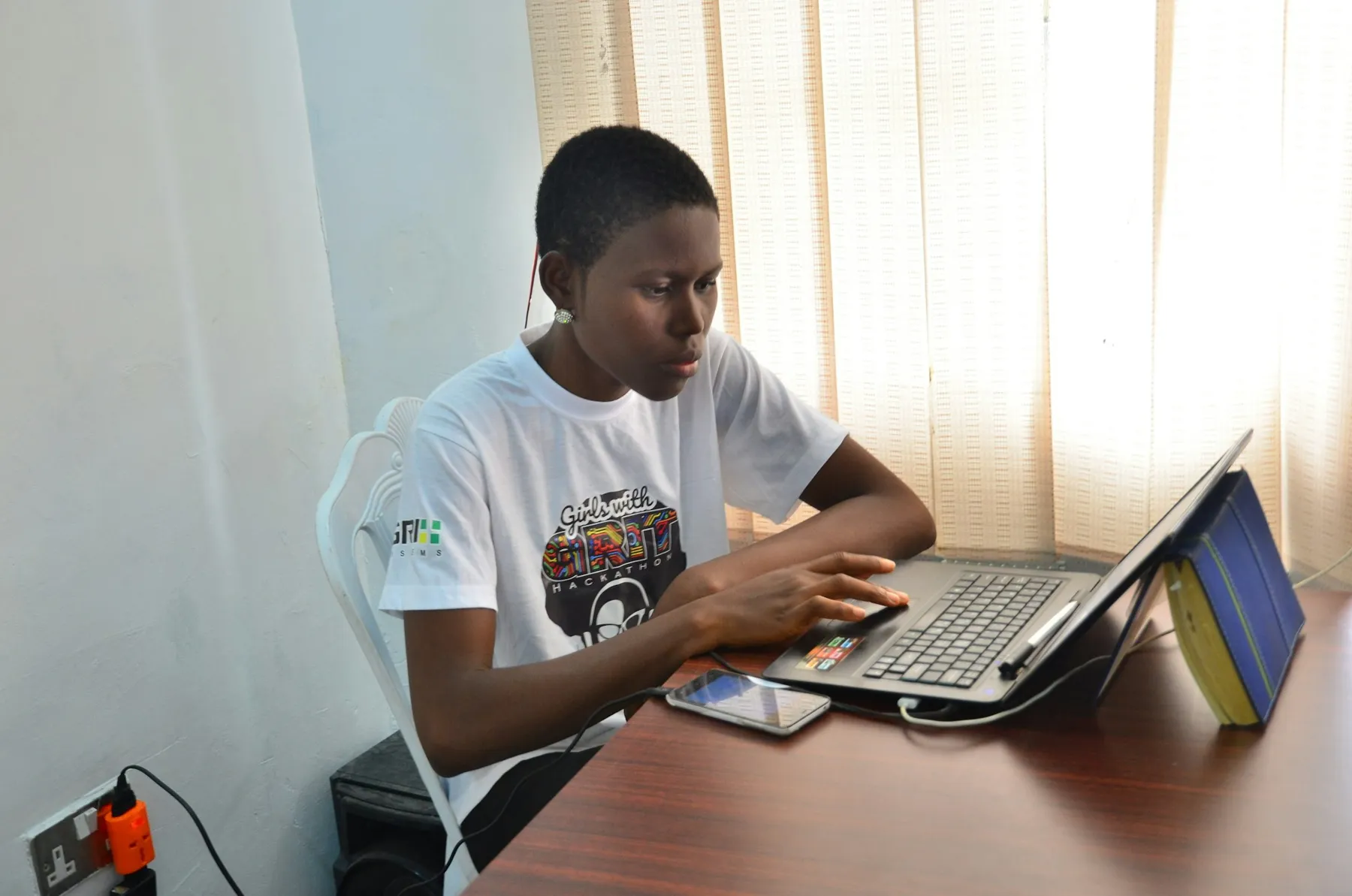 A student working on a laptop in Lagos