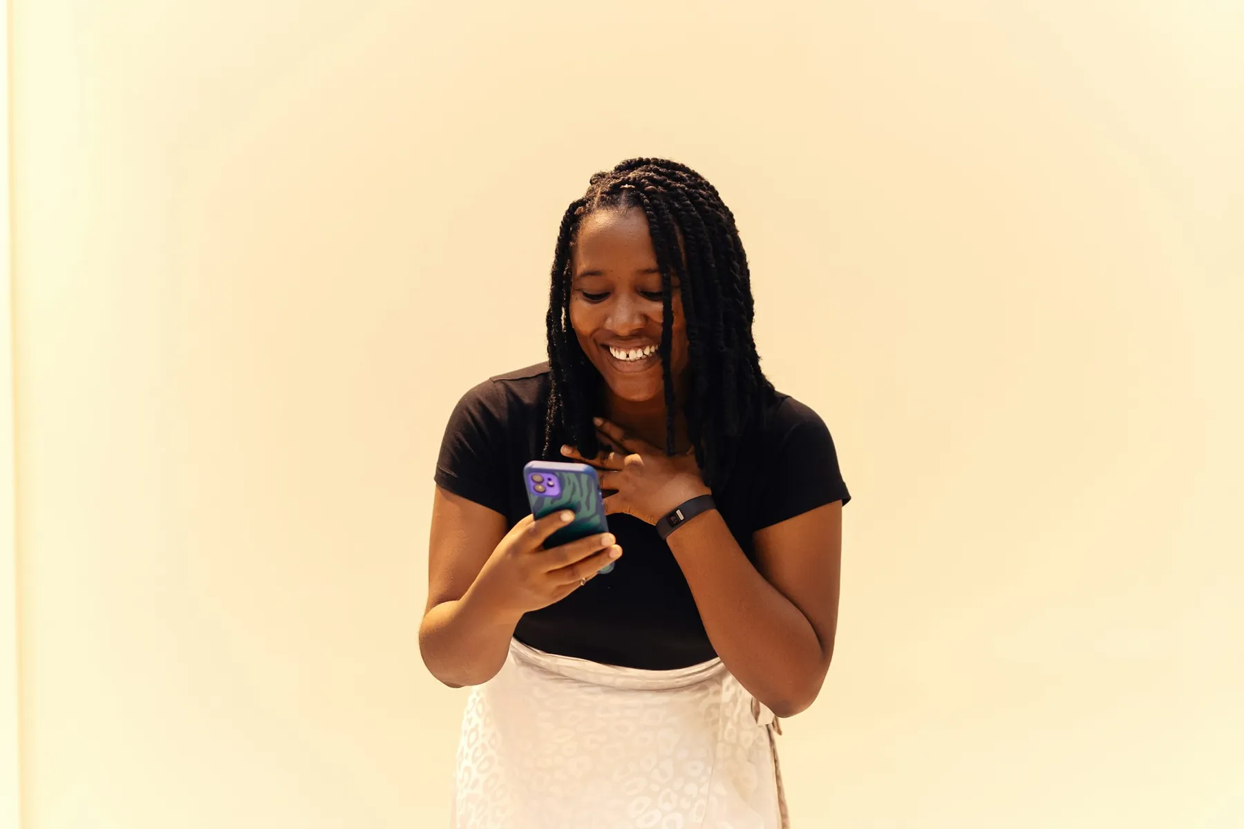 A creator smiling at her phone